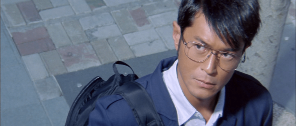 Louis Koo, wearing glasses, as the criminal mastermind "The Brain".